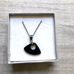 Silver chain with black charm